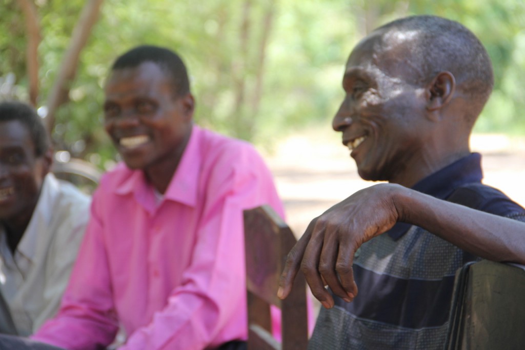 Malawian men group leaders laughing 