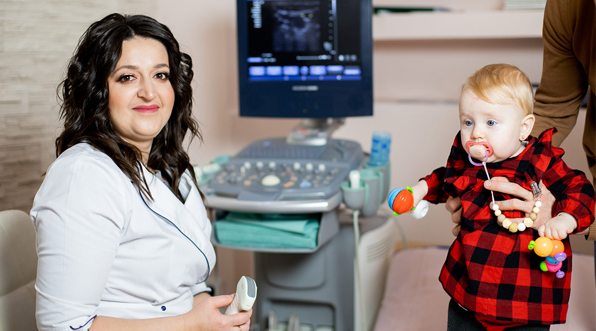 Pediatrician Olga Hoi examines a baby