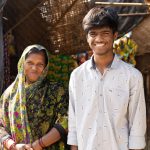 Divya and her son in front of their home